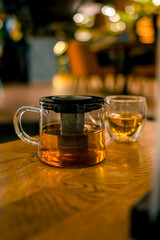 A cup and a teapot on a table in a restaurant. The concept of tea
