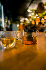 A cup and a teapot on a table in a restaurant. The concept of tea