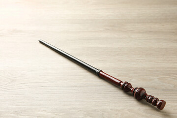 One magic wand on light wooden table