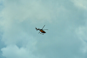 Commercial helicopter fly over the city