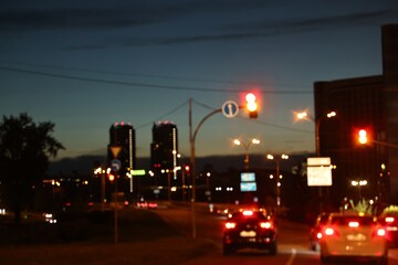 Cityscape with road traffic and street lights in evening