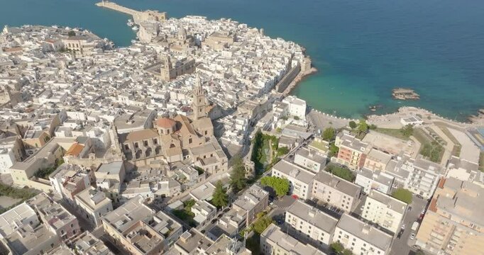 Aerial view of the historic center of Monopoli, in the province of Bari, Apulia, Italy. There are the Basilica of the Madonna della Madia, Palmieri Palace and Cala Porta Vecchia beach.