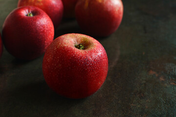 Fresh wet red apples on dark background