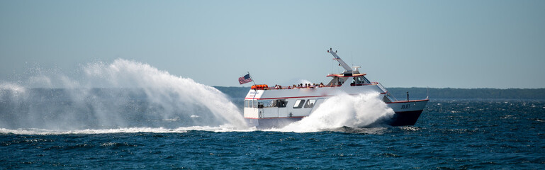 ferry sailing from mackinac island with high speed splashing water
