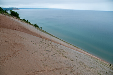 climbing a steep sandy hill at sleeping bear national park