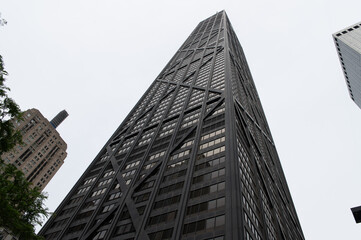 Looking up to a black skycraper in downtown chicago