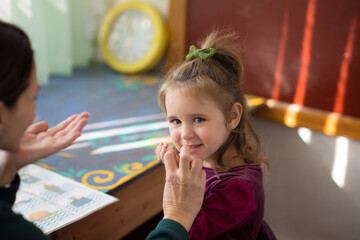 little girl in the speech therapist's office. session with a speech therapist for a child