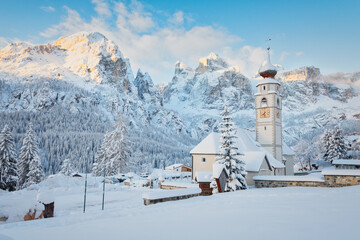 The distinctive church of Colfosco (Kolfuschg) near Corvara with the Sella group Dolomites...