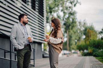 Businesspeople having informal meeting while enjoying coffee outside office