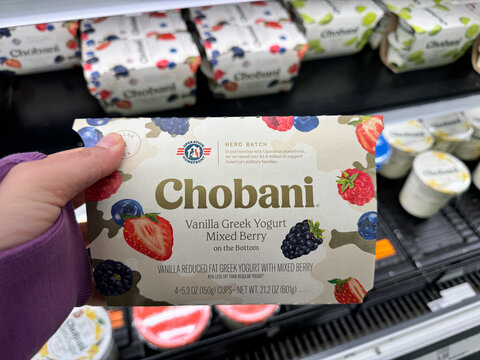 Merrifield, Virginia - November 4, 2024: Hand holds a package of Chobani greek yogurt for sale at a grocery store