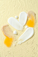 Samples of different cosmetic products on beige background, top view