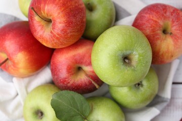 Different whole ripe apples on table, top view
