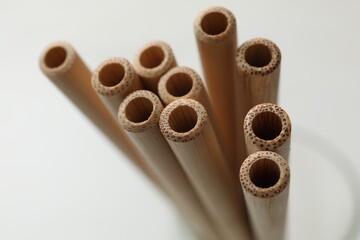 Bamboo drinking straws on blurred background, closeup
