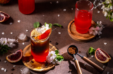 Refreshing espresso and blood orange cocktail decorated with blossoms