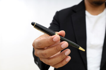 Male arm in suit offering black pen to sign closeup. Corporate sale insurance agent concept