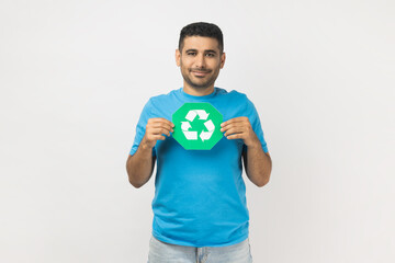 Joyful man holding green recycling sign, calls on to sort rubbish, save our planet from pollution