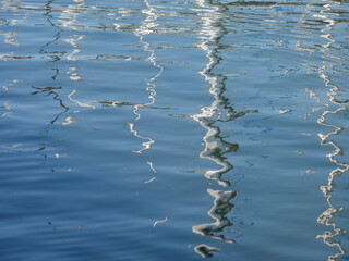 Rippling water reflections at the dock, capturing the serene interplay of light and movement in the afternoon sun