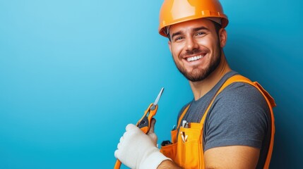A bright and cheerful worker in orange safety gear and helmet, confidently holding pliers in an industrial setting, representing dedication and skill.
