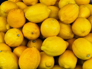 Lemon harvest. Many yellow lemons are collected in a box