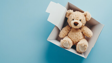 soft teddy bear sits inside white box against blue background, evoking feelings of nostalgia and warmth. This adorable plush toy is perfect for children and collectors alike