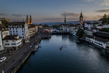 Fototapeta premium Beautiful aerial view of the city of Zurich in Switzerland - the Limmat River and its iconic churches, buildings rivers and Clockes.