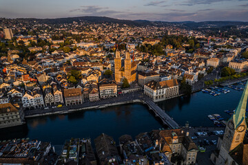 Beautiful aerial view of the city of Zurich in Switzerland - the Limmat River and its iconic churches, buildings rivers and Clockes.
