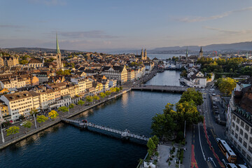Obraz premium Beautiful aerial view of the city of Zurich in Switzerland - the Limmat River and its iconic churches, buildings rivers and Clockes.