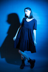 Gothic stylish portrait of a girl in the studio in a neon glow.