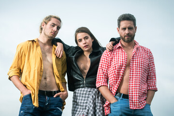 Sexy group of man and two beauty sensual woman. Threesome group. Polyamory three people. Romantic group relationships. Passionately hugging threesome. A group of models.