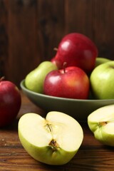 Fresh red and green apples on wooden table