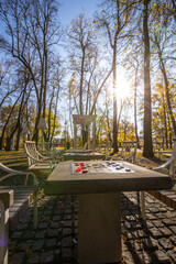 A park with a table and chairs and a bench