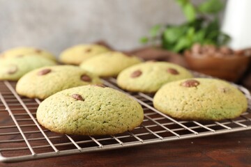 Delicious mint chocolate chip cookies on wooden table, closeup