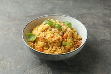 Delicious pumpkin risotto on grey table, closeup