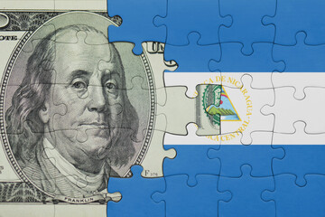 puzzle with the national flag of nicaragua and the usa dollar money .finance concept