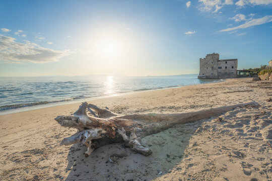 Torre Mozza beach and a trunk with an old building on the sea. Follonica, Italy