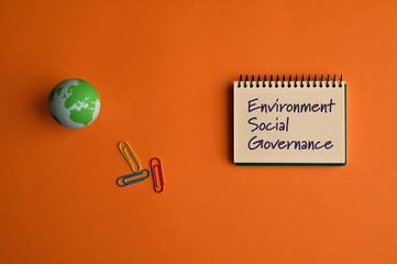 There is notebook with the word Environment Social Governance. It is as an eye-catching image.