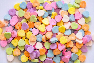 Valentine's Day heart shaped candies for spreading love on the special day. Pile of candy.