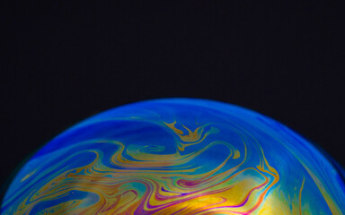 drawing of the earth on a hemisphere in a macro soap bubble on a black background, empty space for an inscription, ecology