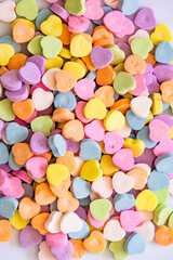 Valentine's Day heart shaped candies for spreading love on the special day. Pile of candy.