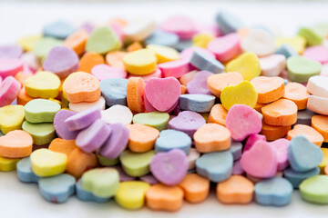 Valentine's Day heart shaped candies for spreading love on the special day. Pile of candy.