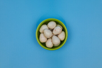 different shapes of gum with different flavors representing white Easter eggs with red spots.