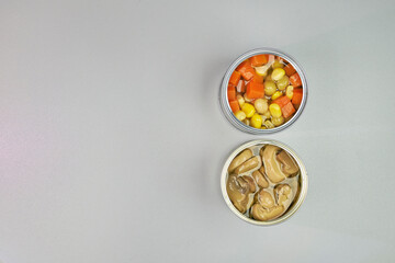 Very colorful canned vegetables, in a zenithal or top shot with a gray background and space for text