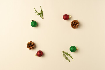 Round frame made of Christmas decoration on beige background. Christmas or new year composition. Flat lay, top view.