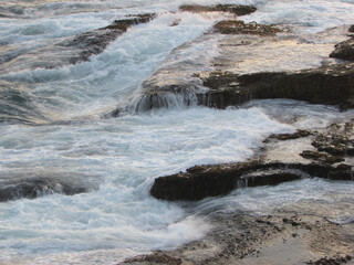 Sea water hitting the rocks of a rock