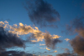 Sunlit white and grey clouds with blue sky horizontally © MiguelA