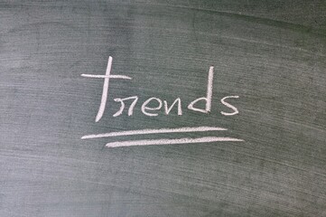 Trends written in chalk on a green chalkboard background - Powered by Adobe