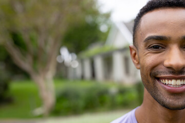 Smiling young african american man enjoying outdoor time in lush green garden, copy space