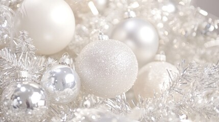 Close-up of white and silver Christmas ornaments and tinsel.