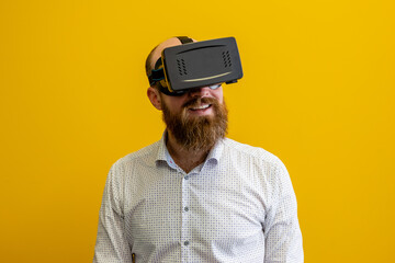 Man wearing a virtual reality device, viewing a virtual world in augmented reality. Using a...
