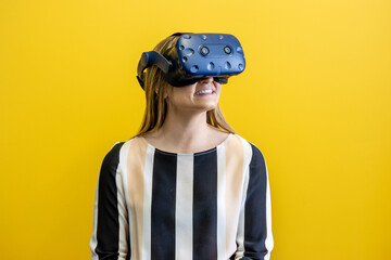Young woman wearing a virtual reality device, viewing a virtual world in augmented reality....